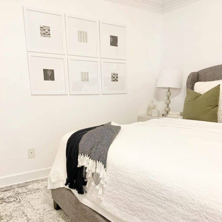 Artwork and White Bedding in Bedroom