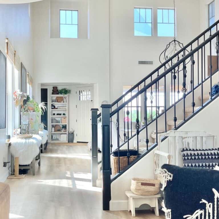 Beige Carpeted Stairway With Black Iron Spindles