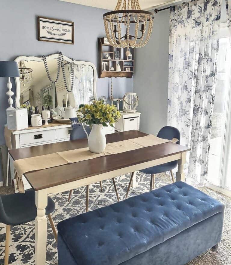 Blue Dining Room With Eclectic Décor and Floral Curtain