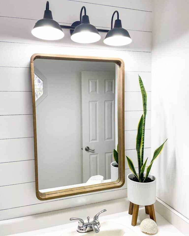 Brass Framed Mirror in Mimimalistic Bathroom