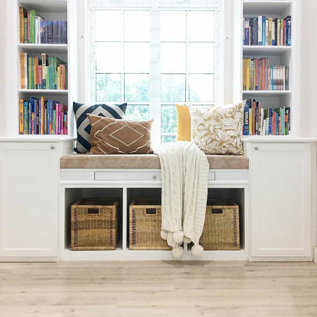 Cozy Window Seat With White Bookshelves