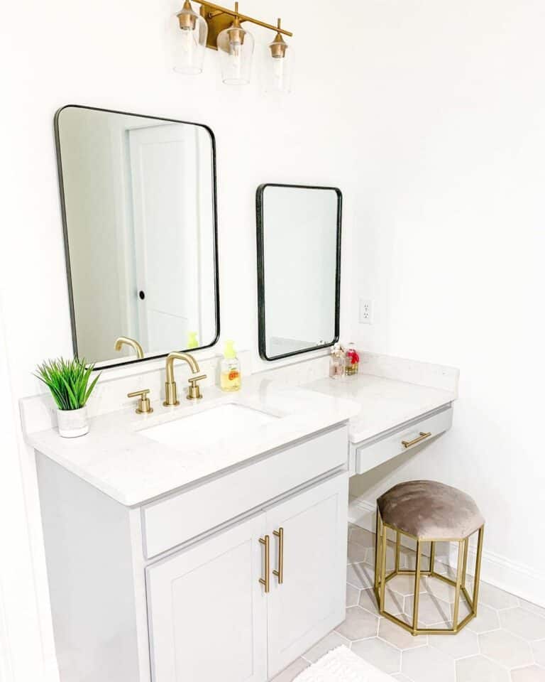 Double Vanity With Brass Sink Handles and Light Fixtures