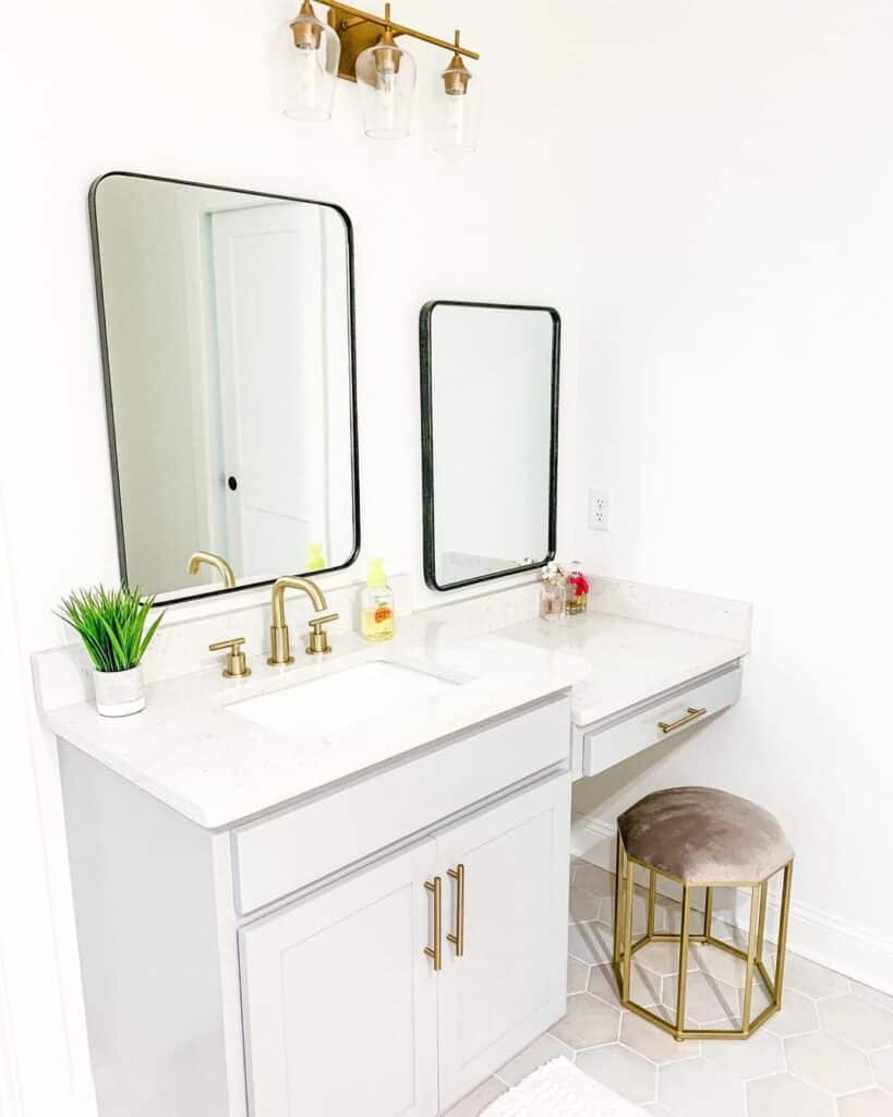 Double Vanity With Brass Sink Handles and Light Fixtures