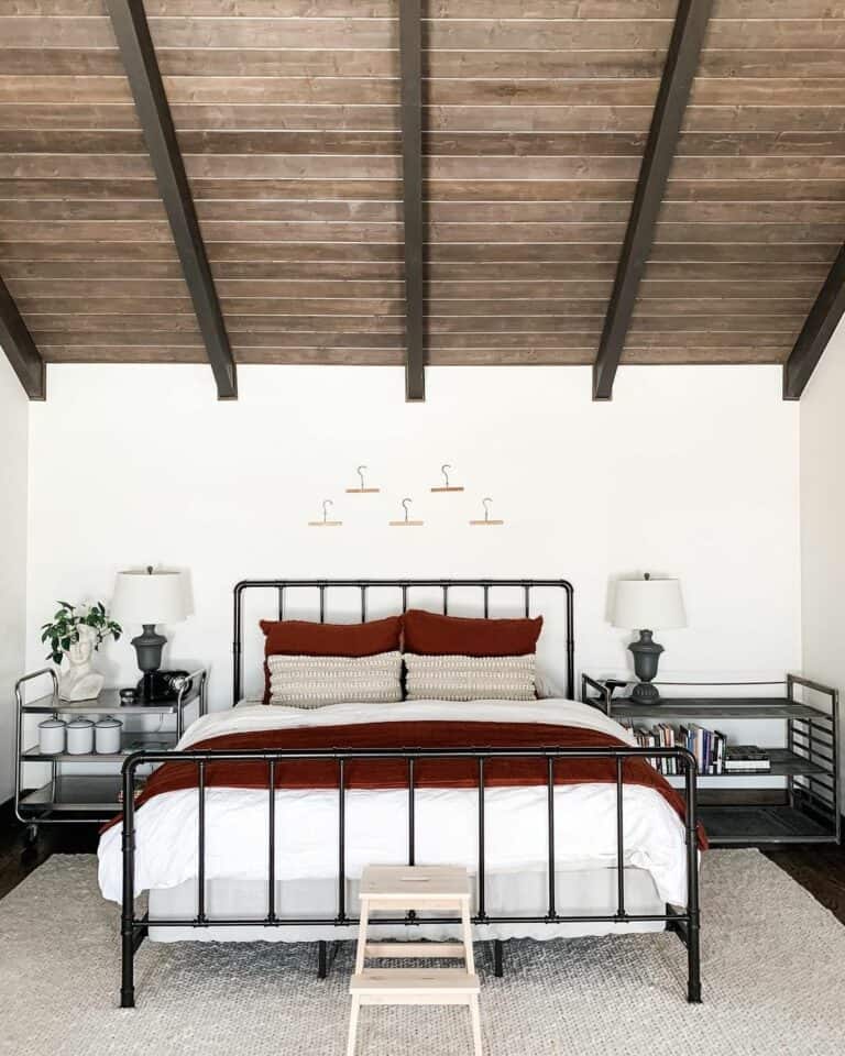 Exposed Wood Beams and Vibrant Color Scheme in Farmhouse Bedroom