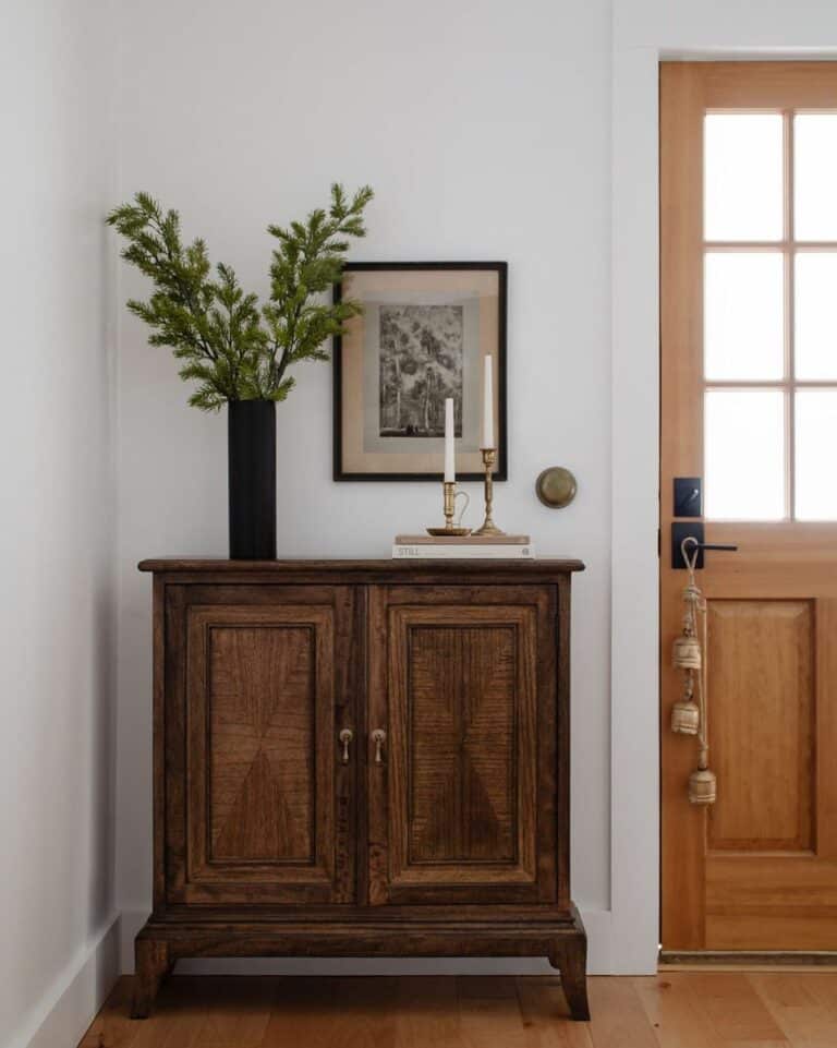 Farmhouse Entryway With Dark Wood Cabinet