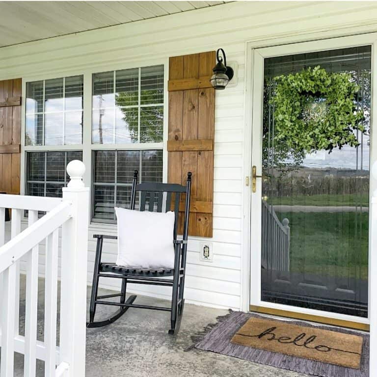 Farmhouse Porch With Decorative Shutters