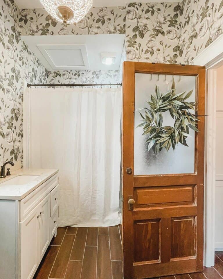 Floral Wallpaper and a Wooden Bathroom Door