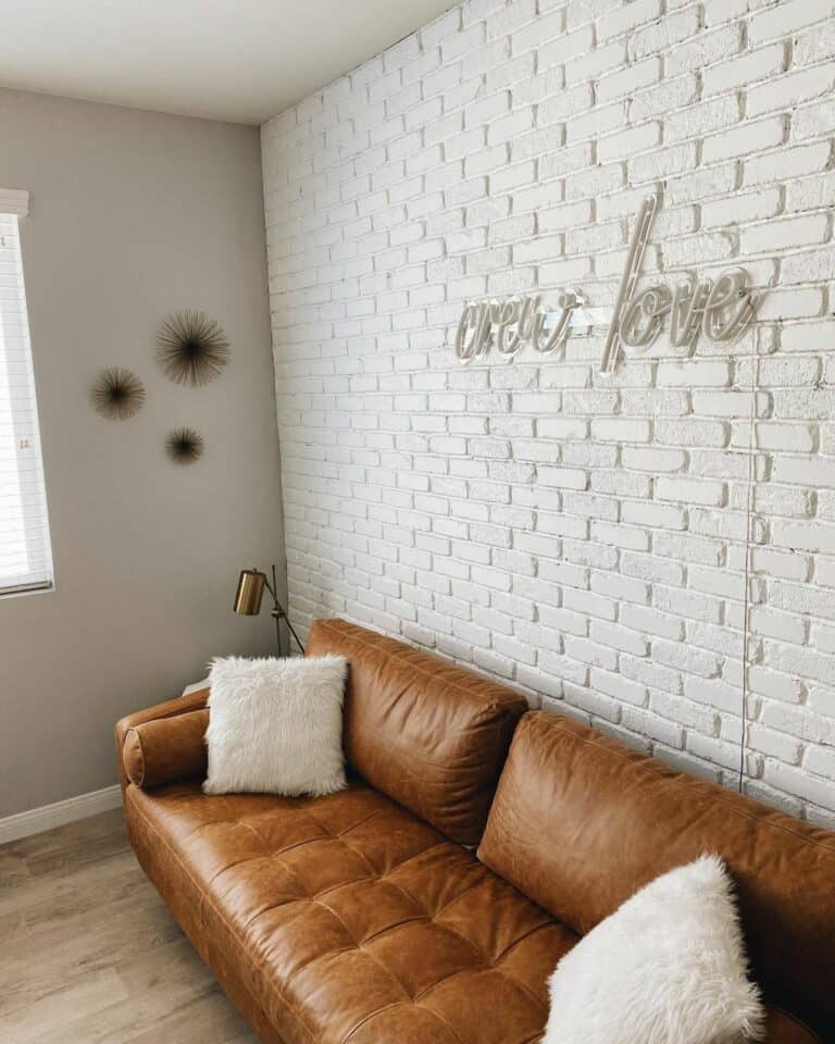 Leather Couch Against a White Brick Wall
