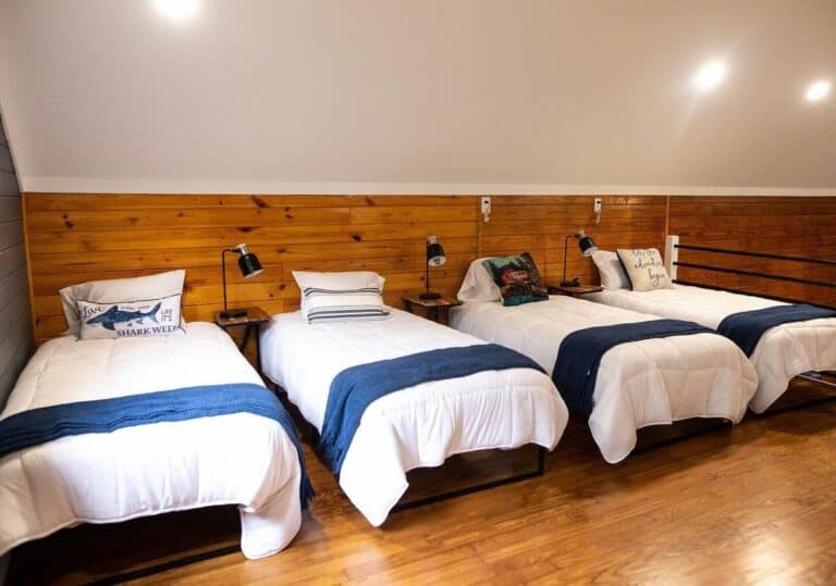 Loft Bunk Room With Rustic Wood Cabin Walls