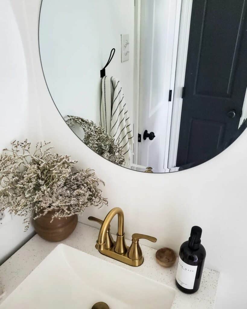 Modern Shiny Brass Faucet and Round Mirror