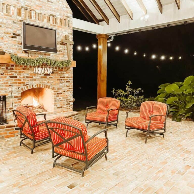 Natural Brick Outdoor Sitting Area With a Roaring Fire