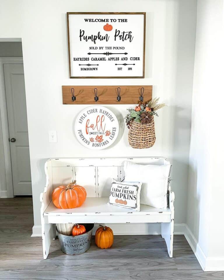 Rustic White Entry Bench With Orange Pumpkins