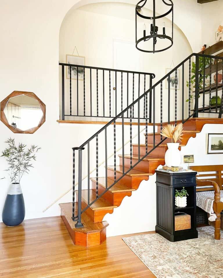 Stained Wood Stairway With Black Metal Balustrade