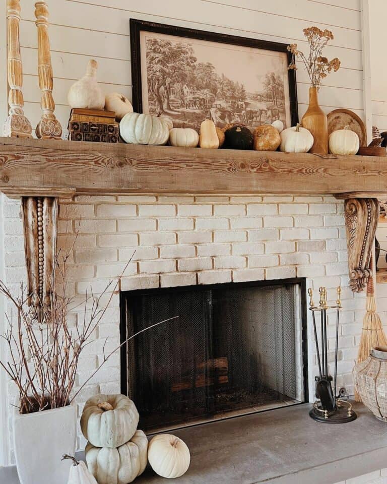 White Brick Fireplace With Pumpkin and Gourd Décor
