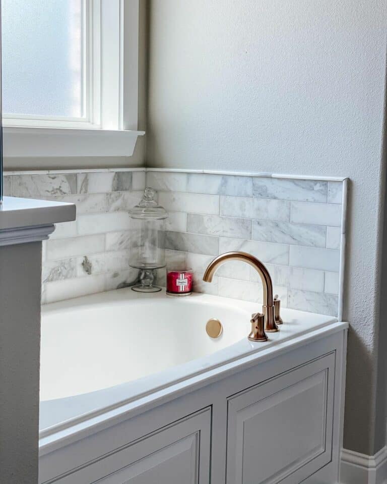 White Drop-in Tub With Marble Subway Tile Surround