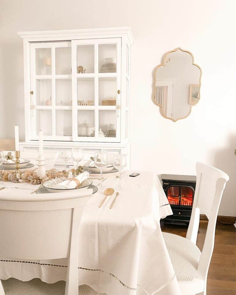 White Farmhouse Dining Room With Gold Accents