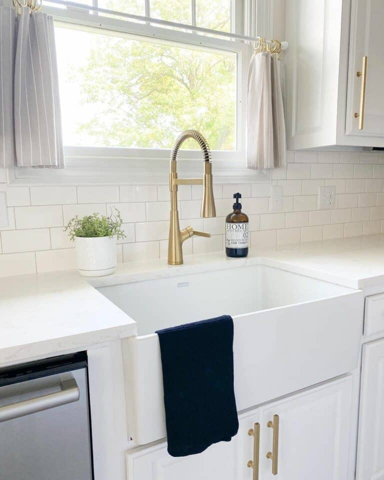 White Modern Kitchen With Golden Faucet