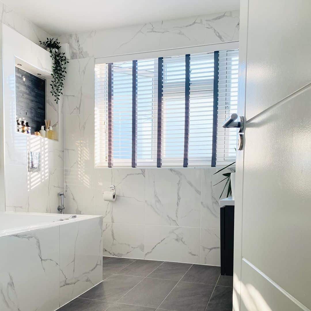 White and Gray Bathroom With Marble Accent Wall - Soul & Lane