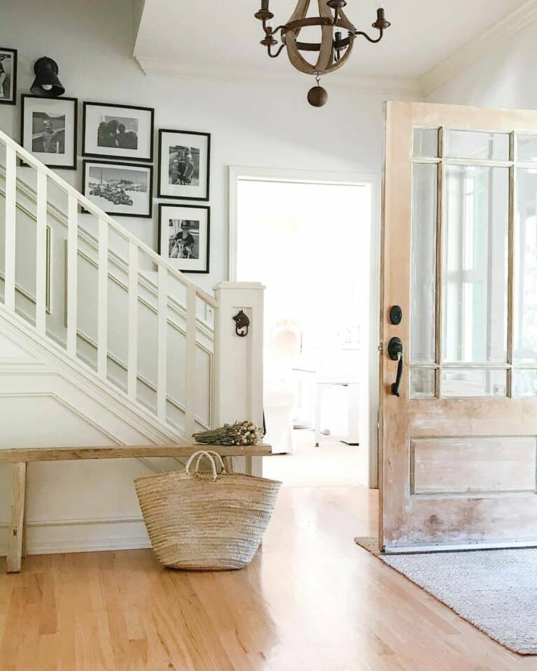 Wood and White Farmhouse Entryway With Framed Photographs