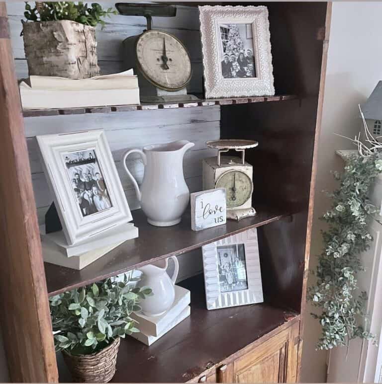 Wooden Display Cabinet With White Photo Frames