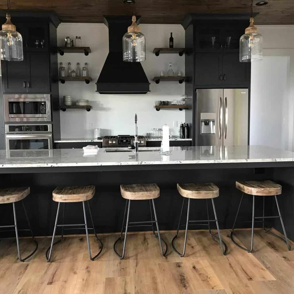 Black Kitchen With Marble Counters and Wood Accents