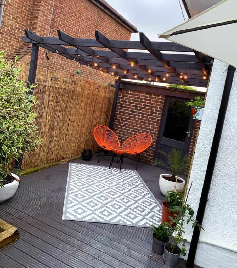 Black Pergola With Orange Hammock Weave Chairs