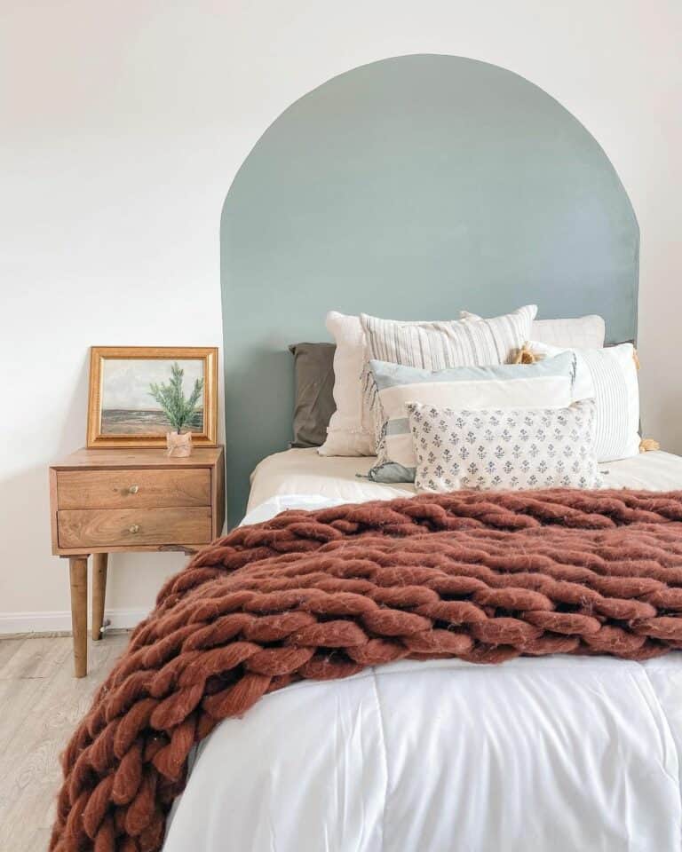 Blue Painted Wall in Bedroom With Wooden Nightstand