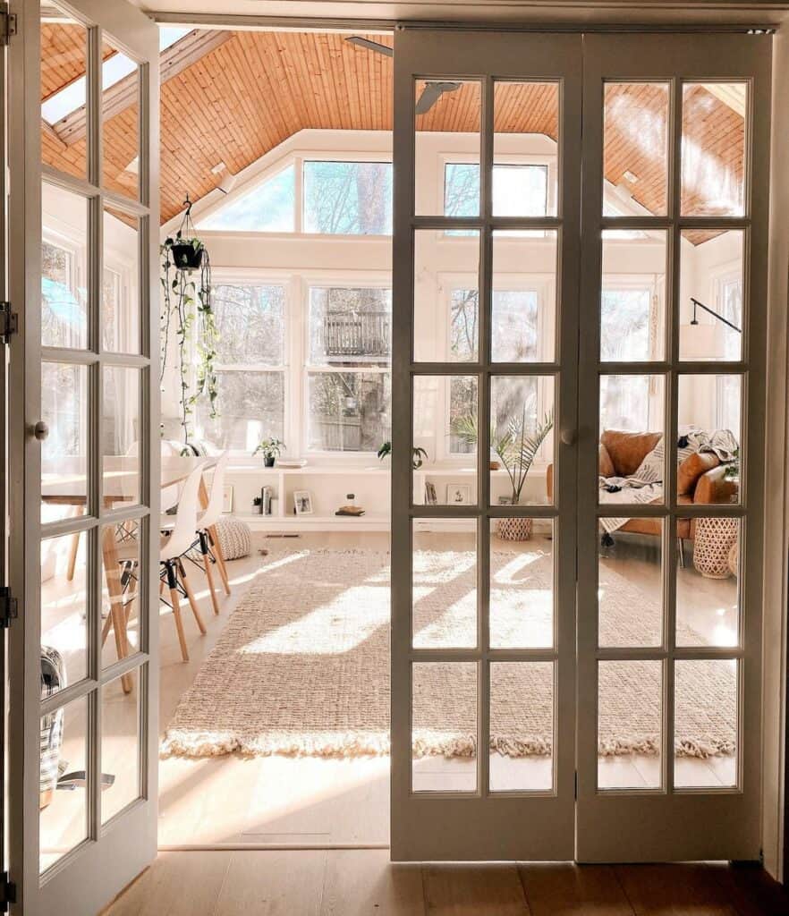 Bohemian Sunroom With Floor to Ceiling Windows