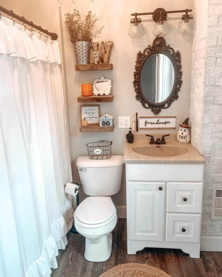 Cottage Bathroom With Ornate Bronze Oval Mirror
