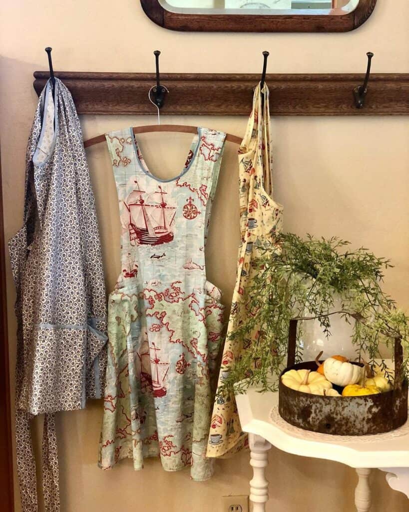 Dark Wood Mounted Hooks and Vintage Aprons