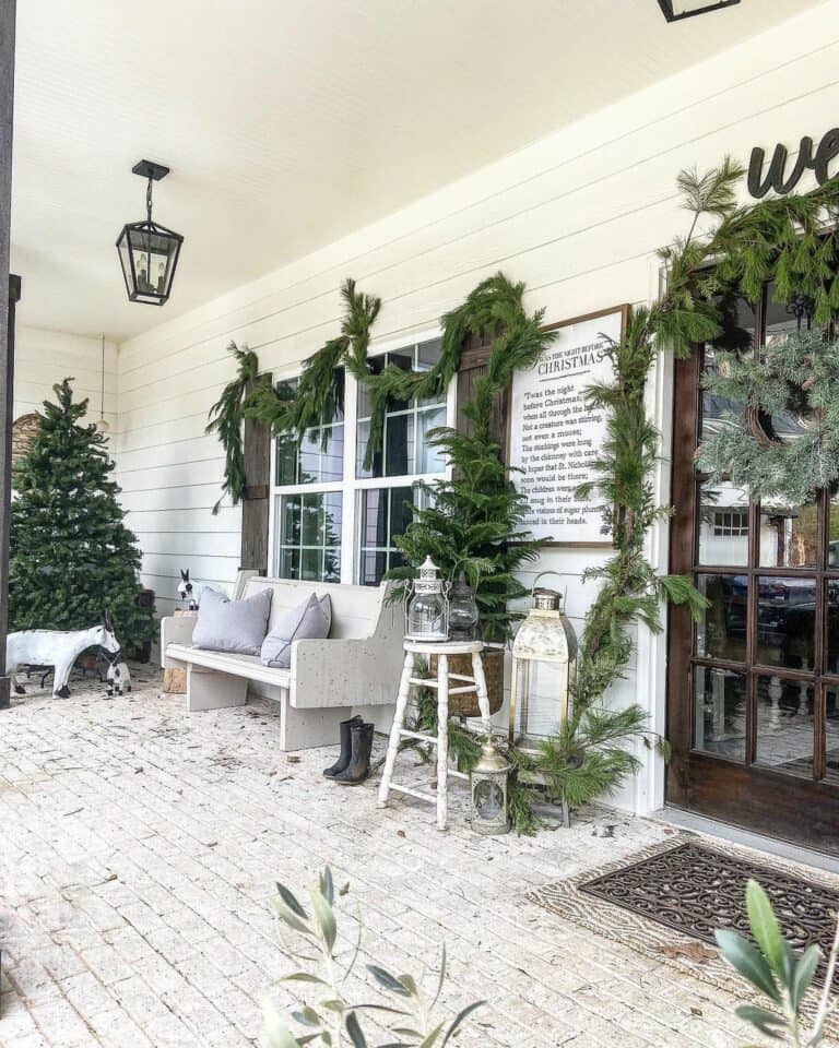 Farmhouse Christmas Porch Decorated With Greenery