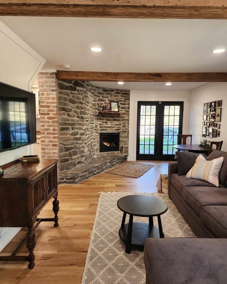 Farmhouse Family Room With Exposed Stone Fireplace