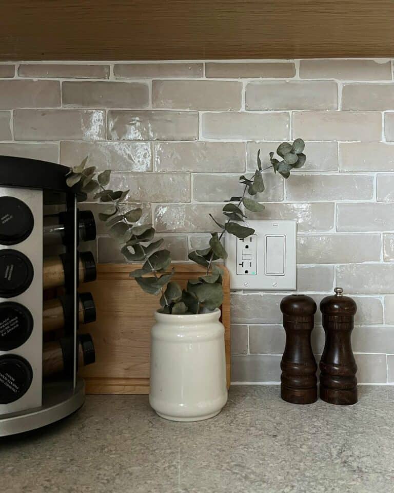 Gray Textured Tile Backsplash With White Grout