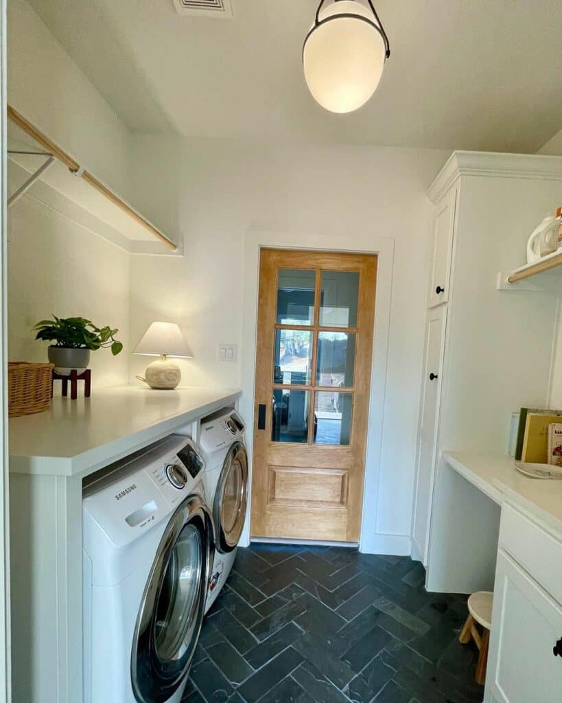Laundry Room With Black Herringbone Tile Flooring - Soul & Lane