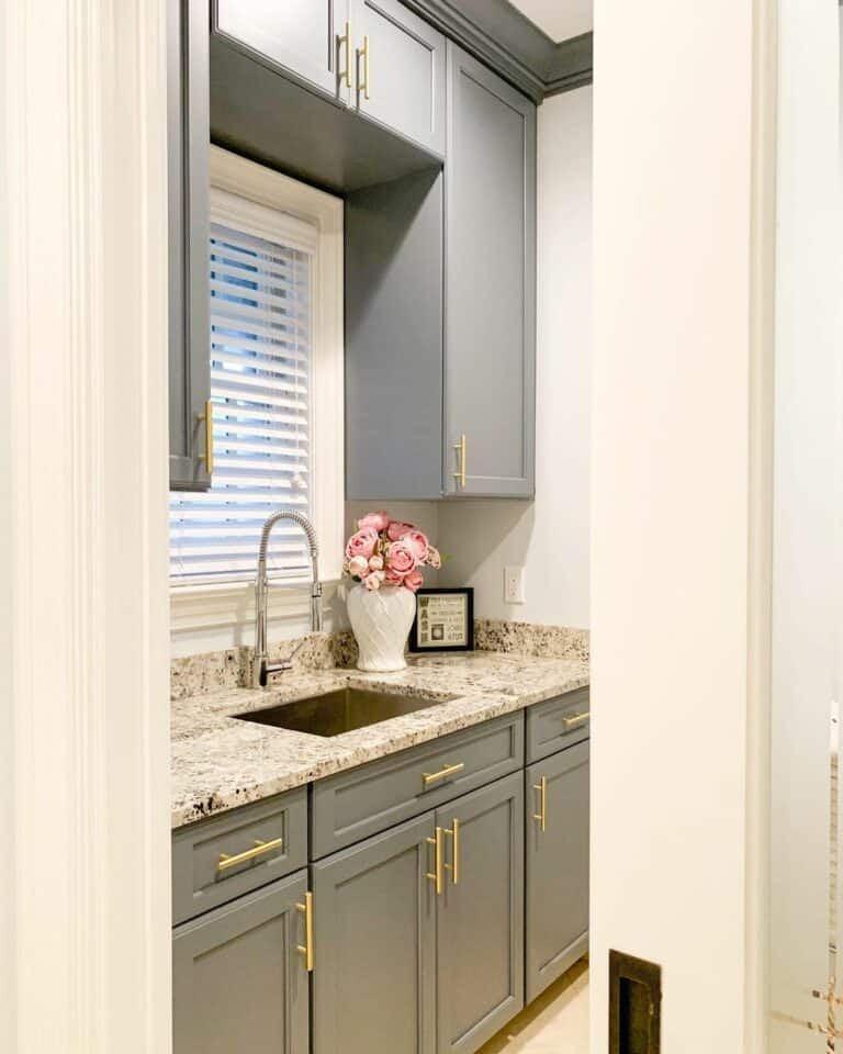 Light Gray Butler's Pantry With Gold Hardware