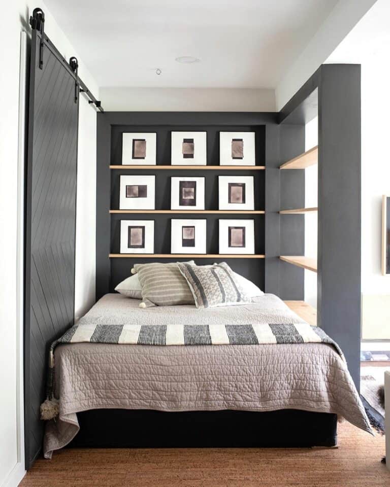 Man's Bedroom With Black Built-in Shelving