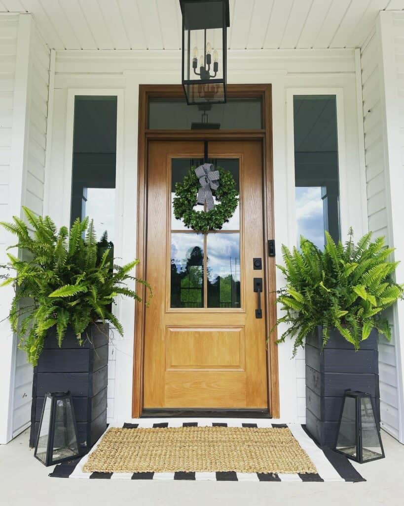 Modern Black and White Porch With Wooden Door