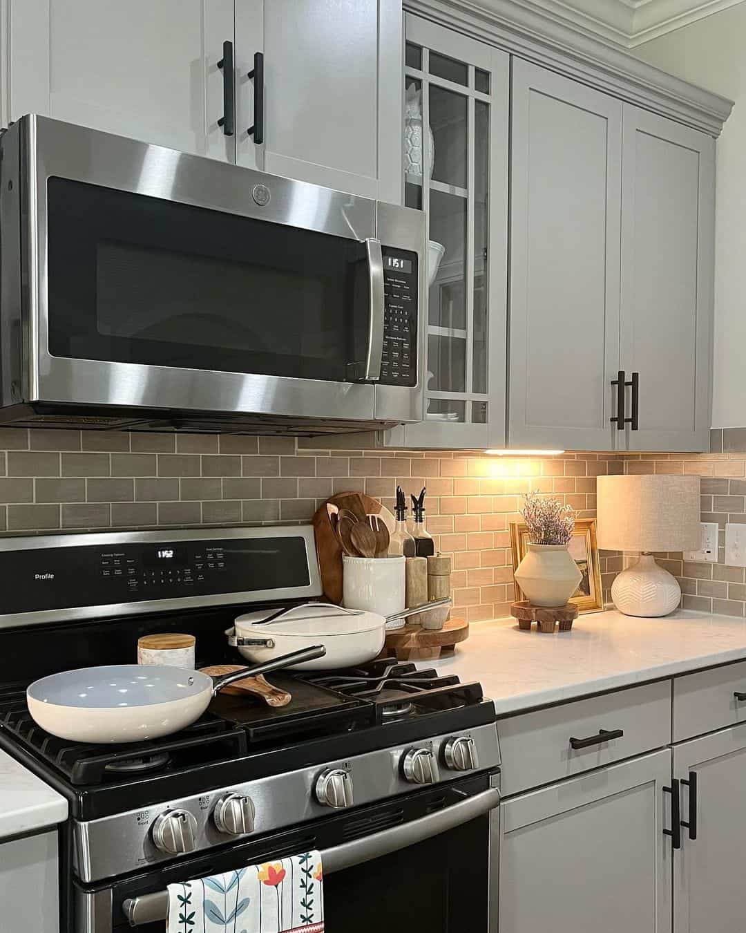 Kitchen With Navy Blue Island and Taupe Cabinetry - Soul & Lane