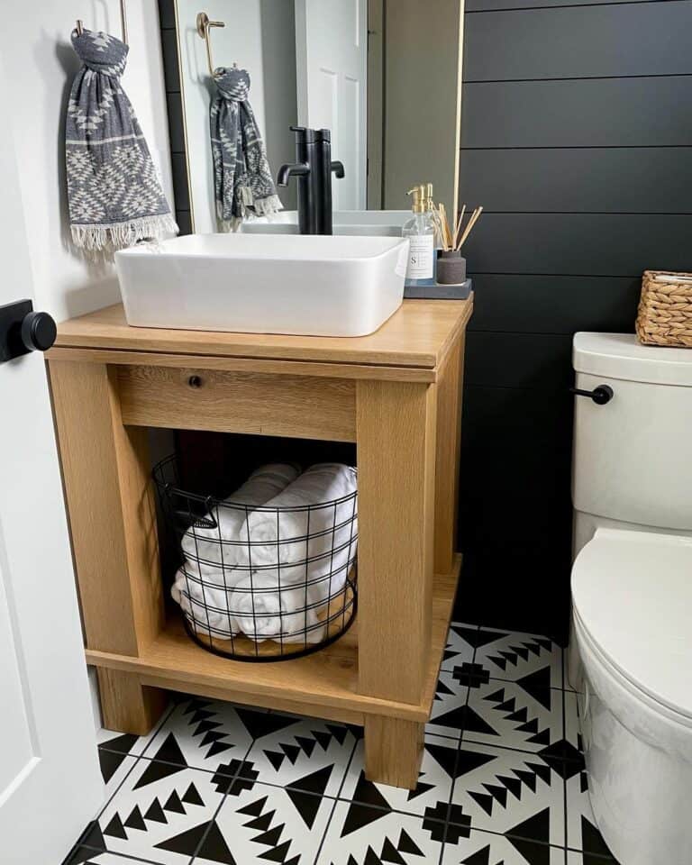Open Wood Storage in a Compact Black and White Bathroom