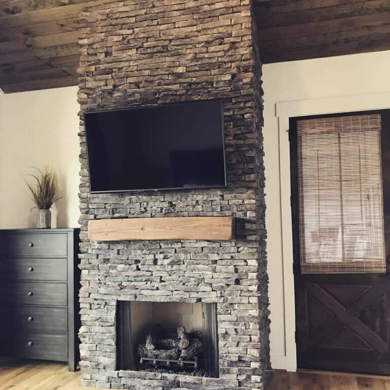 Rustic Vaulted Living Room With Stone Fireplace