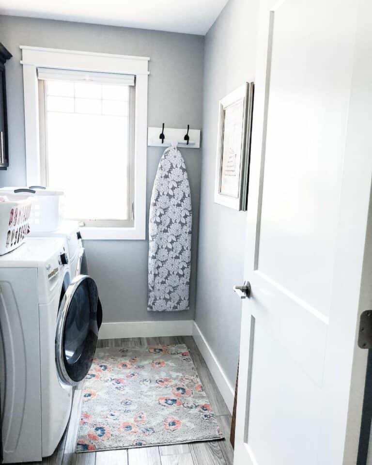 Small Laundry With White and Black Coat Rack