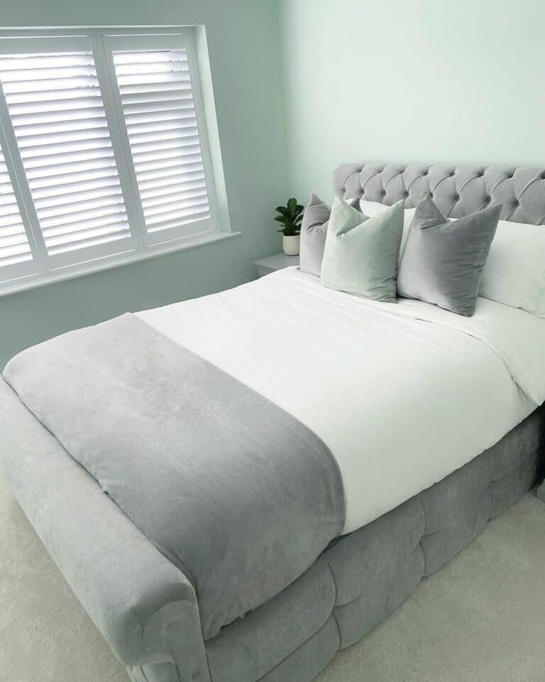 Tufted Bedframe and White Window Shutters