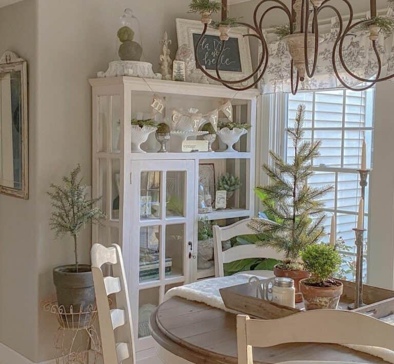 White Display Cabinet With White and Green Antiques