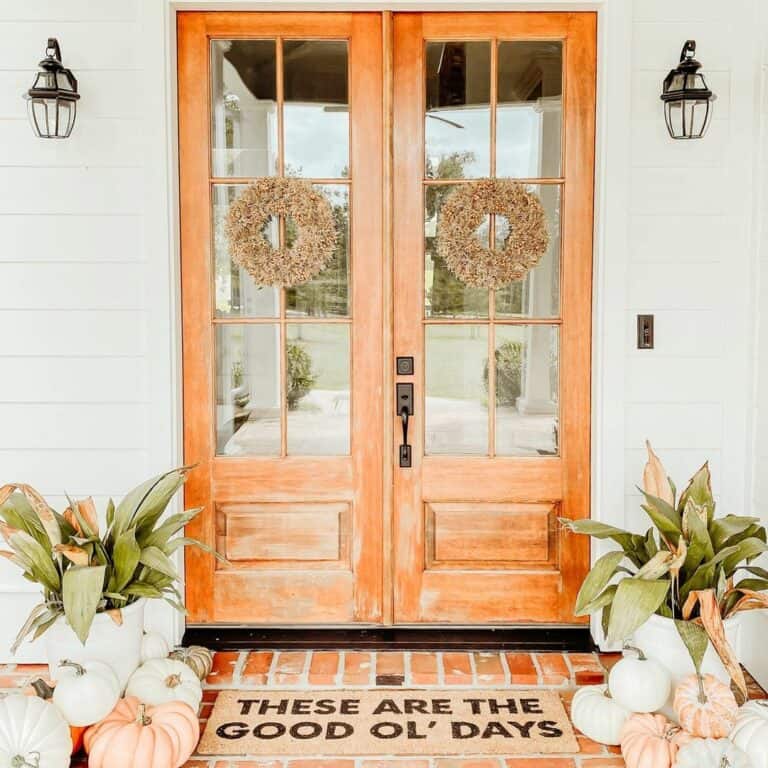 White Farmhouse Porch With Double Wooden Doors