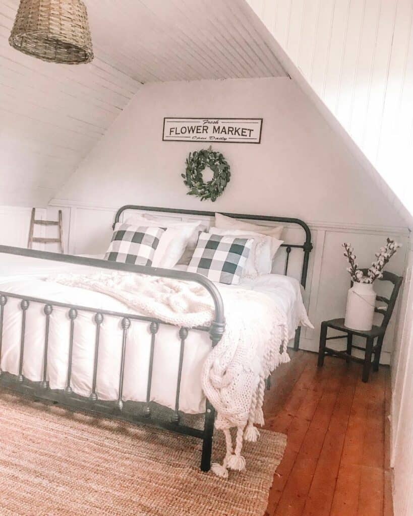White Shiplap Attic Bedroom With Black Metal Bed