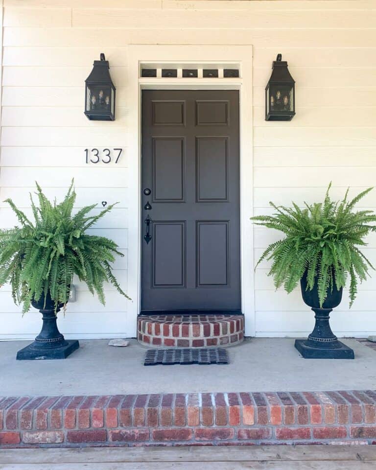 White and Brick Porch With Black Accent Door