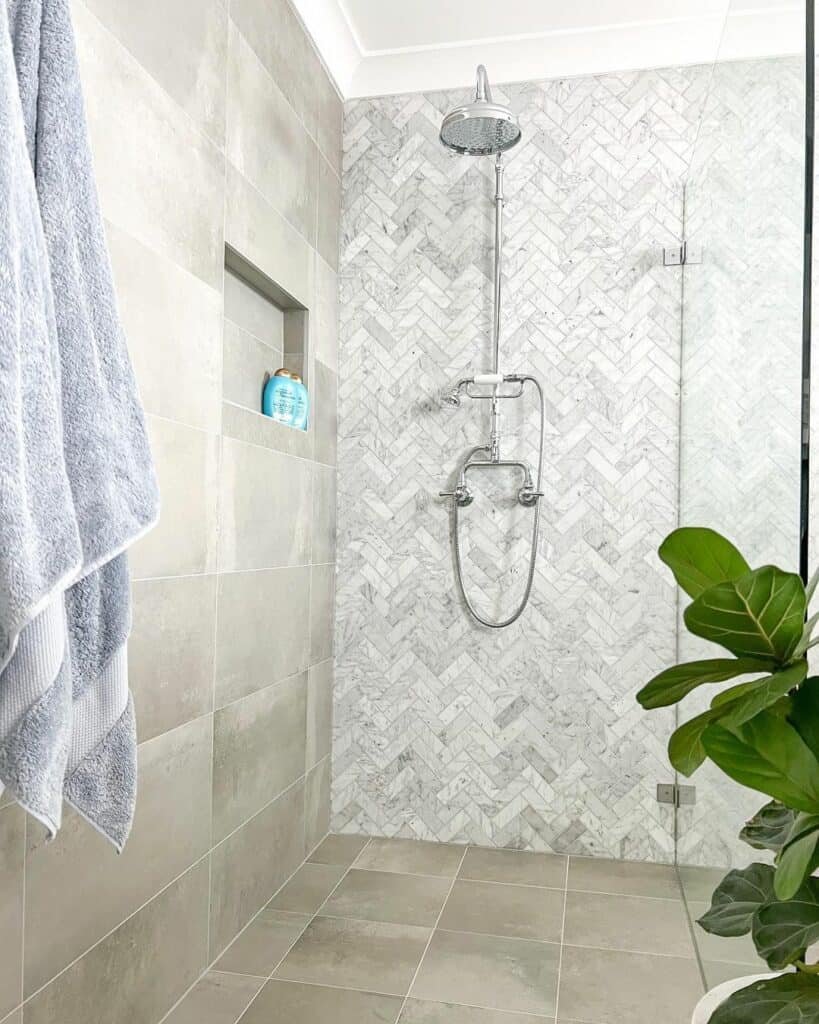 White and Gray Herringbone Shower Accent Wall