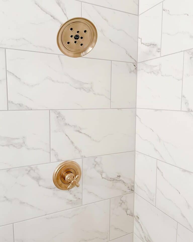 White and Gray Marble Tile Shower With Gold Accents