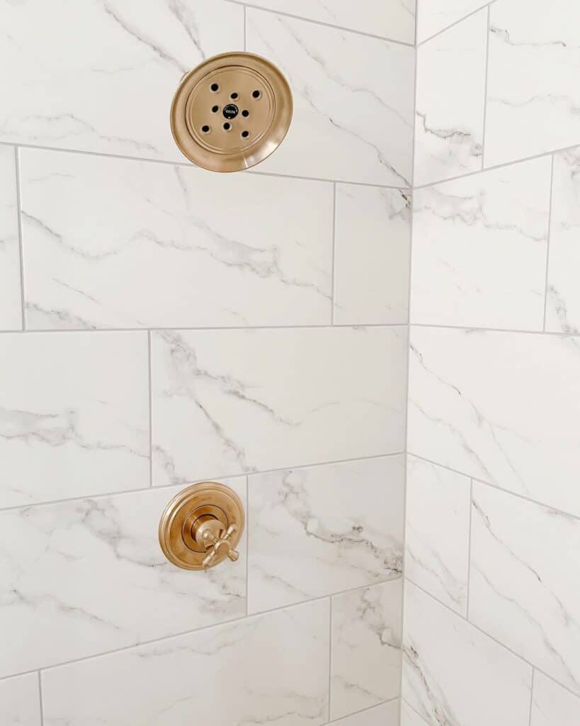 White and Gray Marble Tile Shower With Gold Accents Soul & Lane