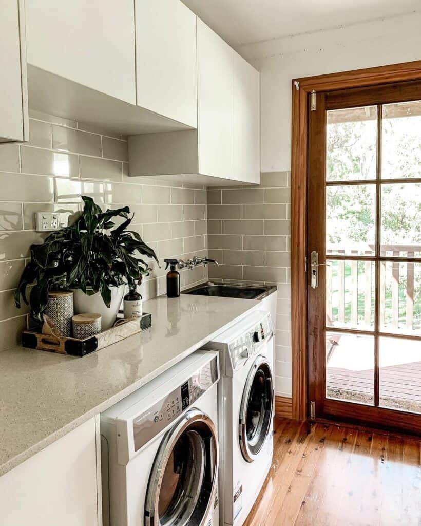 Airy Farmhouse Laundry Room With Gray Tile